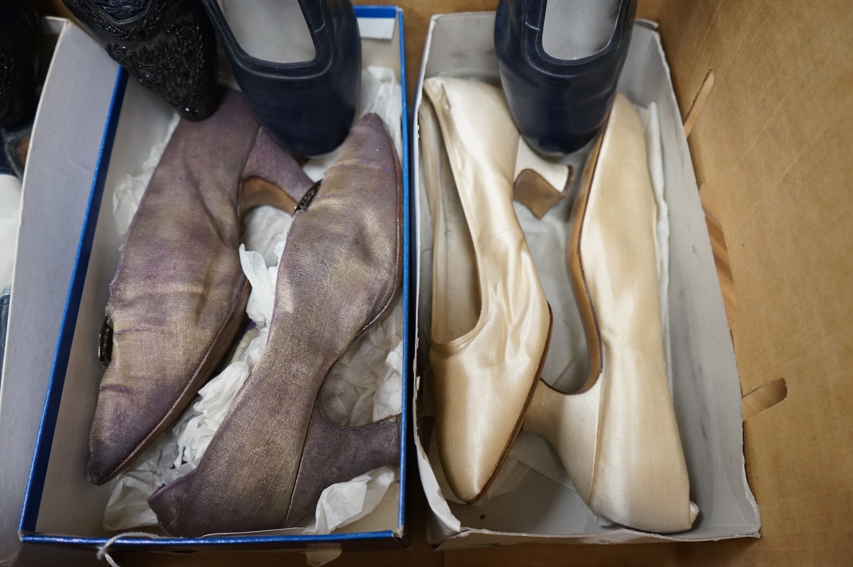 Five pairs of ladies shoes from 1900-1940's; a pair black leather and jet shoes, a pair of cream silk wedding shoes, lilac evening shoes, a pair of two tone leather shoes and a similar navy pair